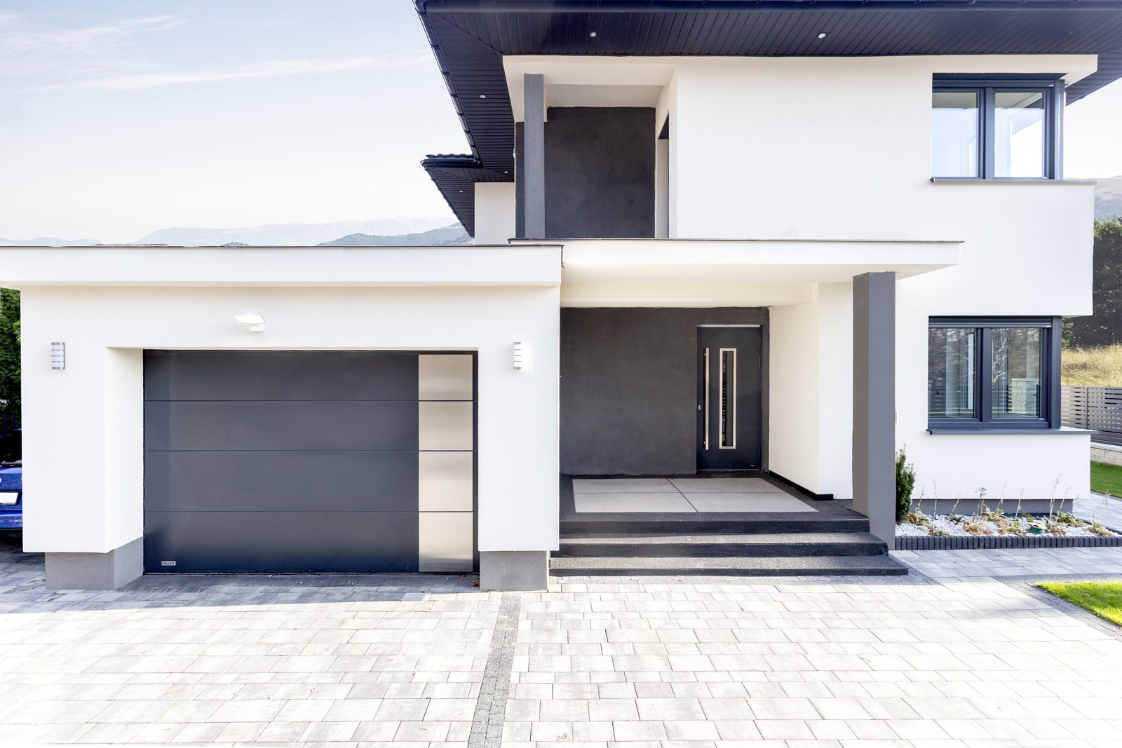 Grey and timber house with matching garage door, front door and shutters