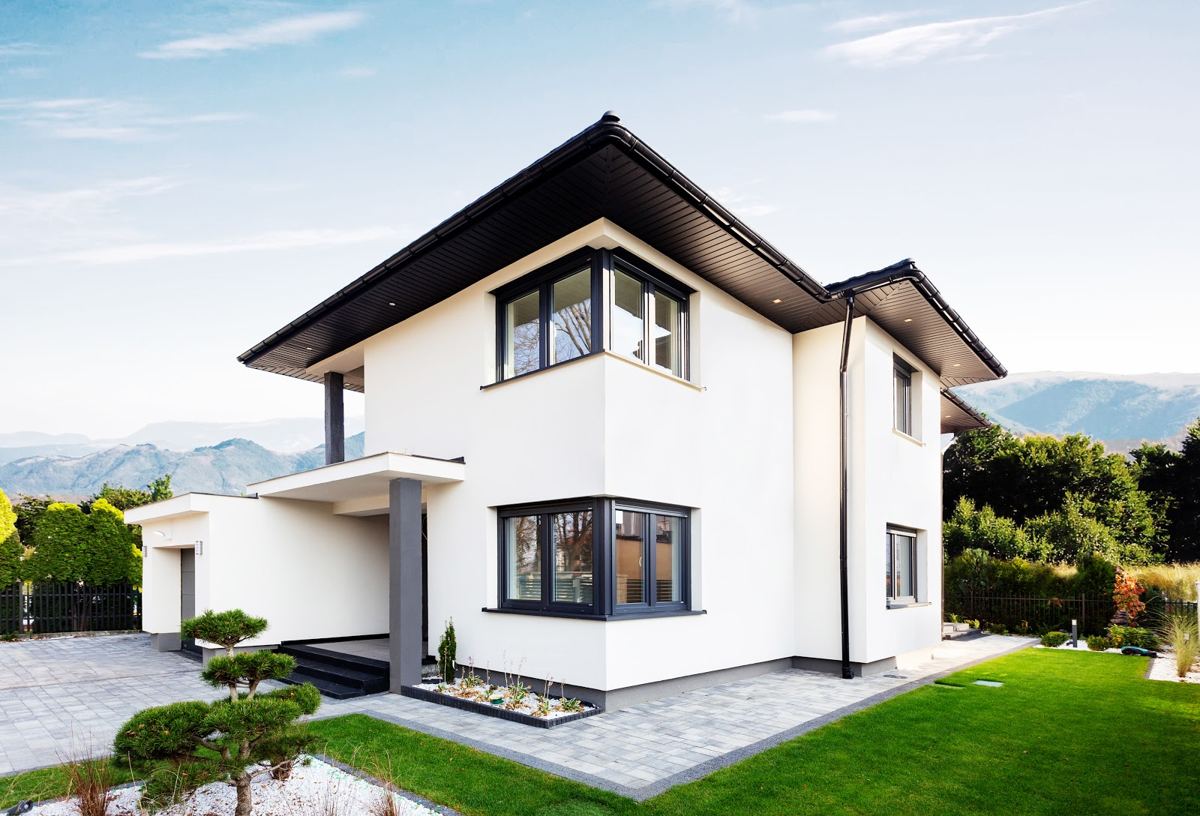 White two-storey house with dark-framed corner windows