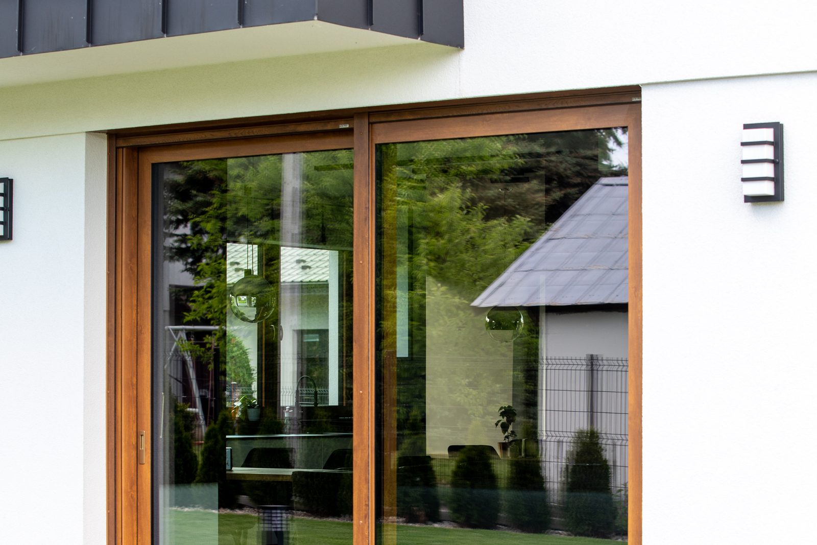 Timber-framed sliding patio door on a white house